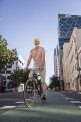 Älterer Mann fährt Fahrrad in der Stadt - WESTF23577