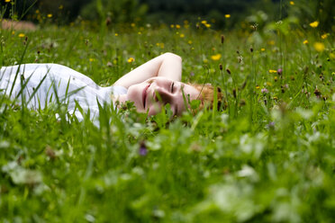 Teenage girl relaxing on a meadow - LBF01633