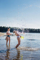 Children splashing with water at lakeshore - MJF02175