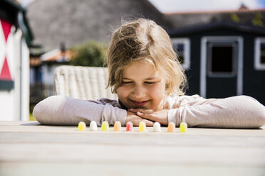 Girl looking at sweets on table - MOEF00071