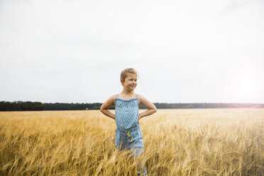 Girl standing in grain field at sunset - MOEF00077