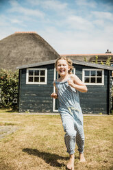 Happy girl running in garden - MOEF00081