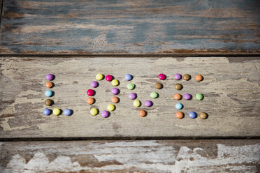 Chocolate drops forming the word love on wooden table - MOEF00110