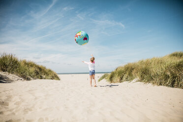 Mädchen spielt mit Globus am Strand - MOEF00123