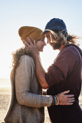 Portugal, Algarve, affectionate couple on the beach at sunset - JRF00336