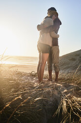 Portugal, Algarve, couple hugging at sunset on the beach - JRF00338