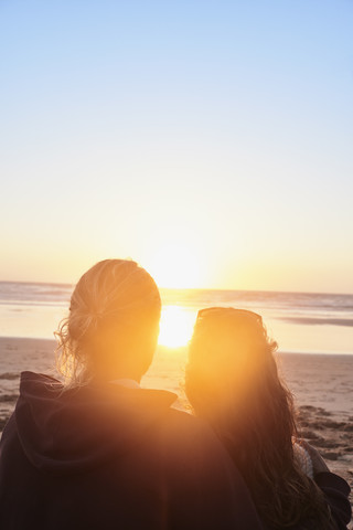 Portugal, Algarve, couple on the beach at sunset stock photo