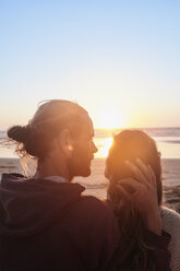 Portugal, Algarve, affectionate couple on the beach at sunset - JRF00345