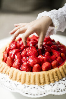 Girl's hand taking strawberry from cake - MOEF00137