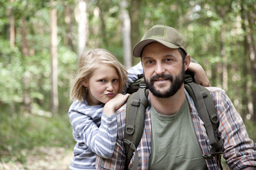 Portrait of smiling father and daughter in forest - MFRF01015