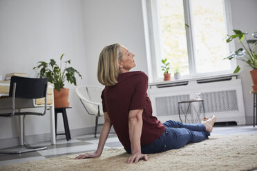 Relaxed mature woman sitting on the floor at home - RBF05892