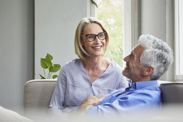 Happy mature couple on couch at home - RBF05899