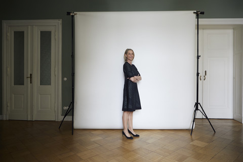 Portait of confident mature woman posing at projection screen stock photo