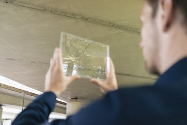 Businessman using portable glass device - KNSF02490