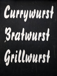 Sign offering three german sausage delicacies - JMF00402
