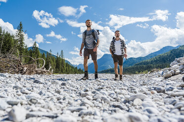 Germany, Bavaria, two hikers walking in dry creek bed - DIGF02781
