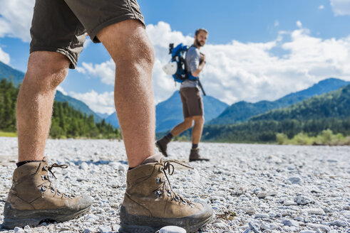 Germany, Bavaria, legs of hiker walking in dry creek bed - DIGF02789