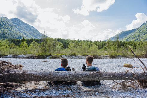 Germany, Bavaria, back view of two hikers having a rest - DIGF02795