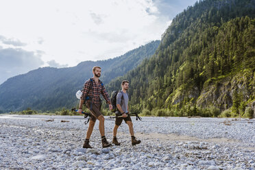 Germany, Bavaria, two hikers walking in dry creek bed - DIGF02822