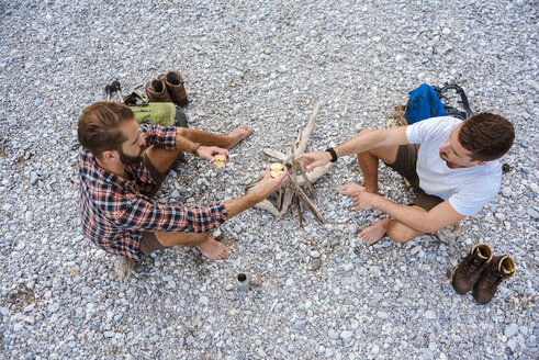 Two hikers having a rest at camp fire, top view - DIGF02838