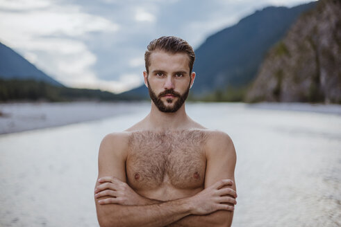 Germany, Bavaria, portrait of shirtless young man in nature - DIGF02844