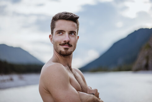 Germany, Bavaria, portrait of shirtless young man in nature - DIGF02845