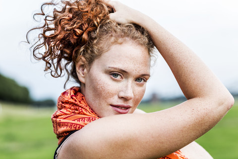 Portrait of freckled young woman with curly red hair stock photo