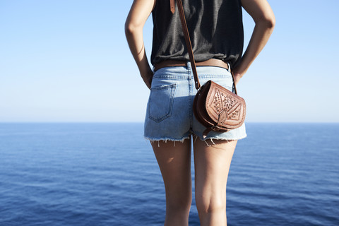 Back view of woman looking at the sea, partial view stock photo