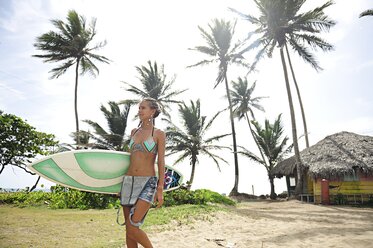 Woman at the coast with surfboard - ECPF00068