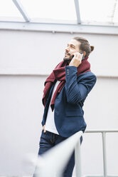 Portrait of smiling businessman on the phone - JOSF01531