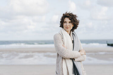 Woman standing on the beach - KNSF02553