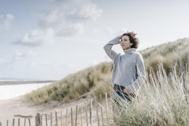 Woman standing in beach dune - KNSF02578