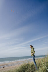 Woman standing in beach dune - KNSF02601