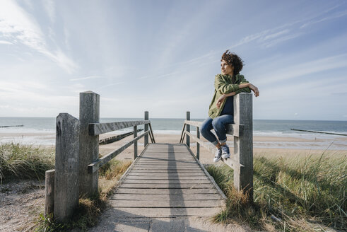 Woman on boardwalk at the beach - KNSF02603