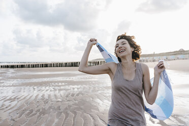 Happy woman with cloth on the beach - KNSF02640
