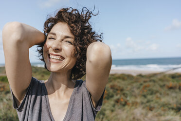 Portrait of happy woman at the coast - KNSF02664