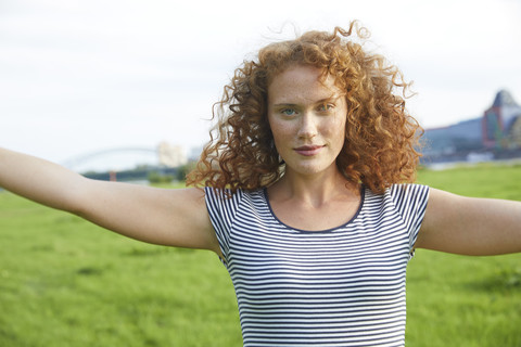 Portrait of smiling young woman on a meadow in summer stock photo