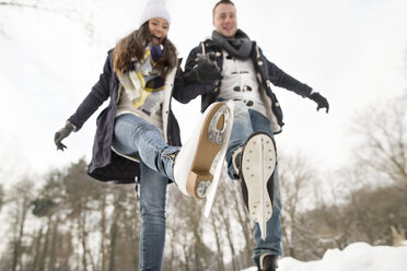 Couple ice skating on a frozen lake - HAPF02114