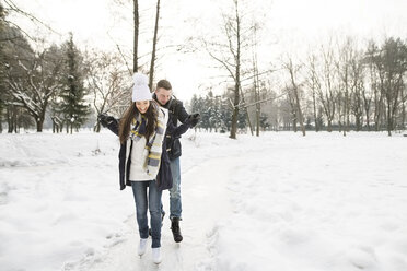 Couple ice skating on a frozen lake - HAPF02115