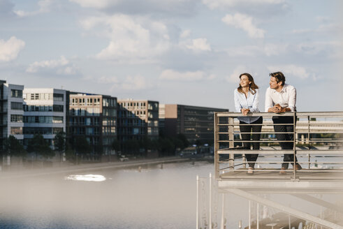 Business people standing on balcony - KNSF02806