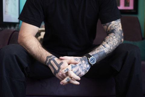 Arms of tattoo artist in studio stock photo