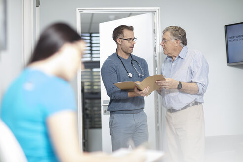 Doctor with file talking to patient in medical practice - ZEF14537