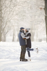 Senior couple hugging on frozen lake - HAPF02152