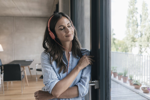 Relaxed woman listening to music at home - JOSF01560