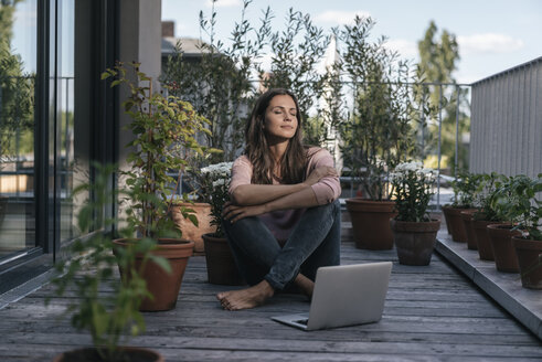 Woman with laptop sitting on balcony - JOSF01622
