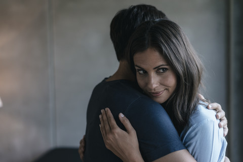 Smiling woman embracing man stock photo