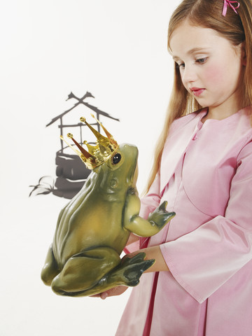 Porträt eines kleinen Mädchens, das den Froschkönig beobachtet, lizenzfreies Stockfoto