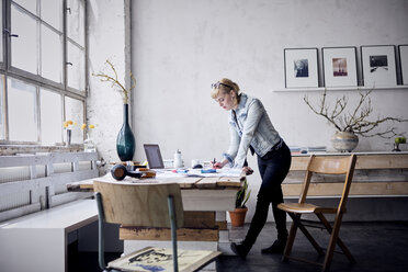 Woman working at desk in a loft - RBF05969