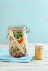 Preserving jar of vegan mixed salad with tofu and pasta and jar of cocktail sauce - ECF01881