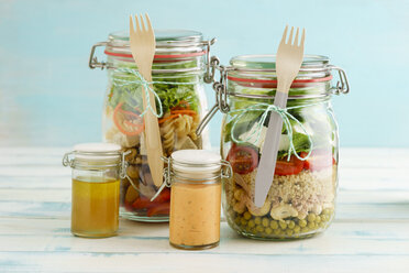 Preserving jars of mixed salads and jars of dressings - ECF01883